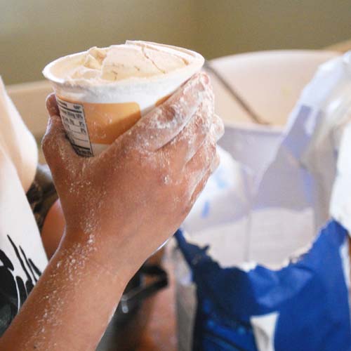 Measuring flour from the empty yogurt container